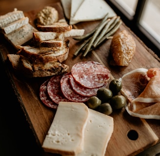 a wooden cutting board topped with lots of food