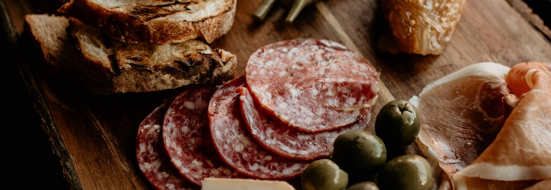 a wooden cutting board topped with lots of food